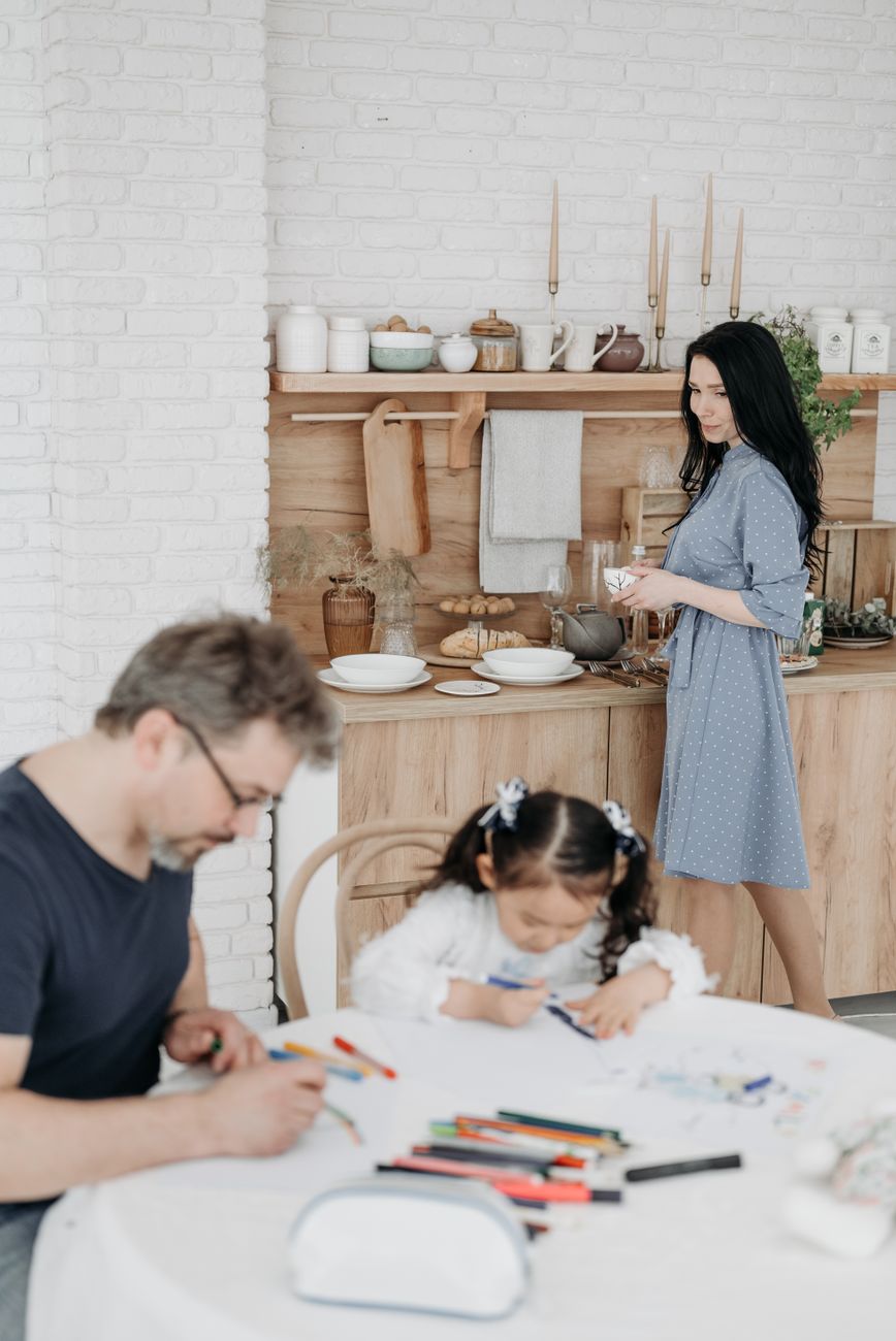 Young girl quietly absorbed in drawing at the family dining table